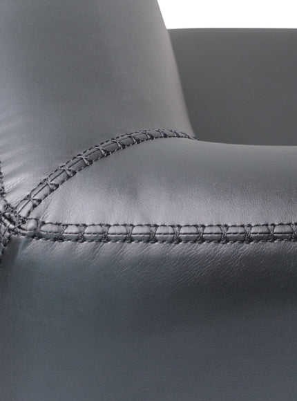 Close-up of the Vaya Home Regalo sofa showing black leather upholstery and stitched seam detail.