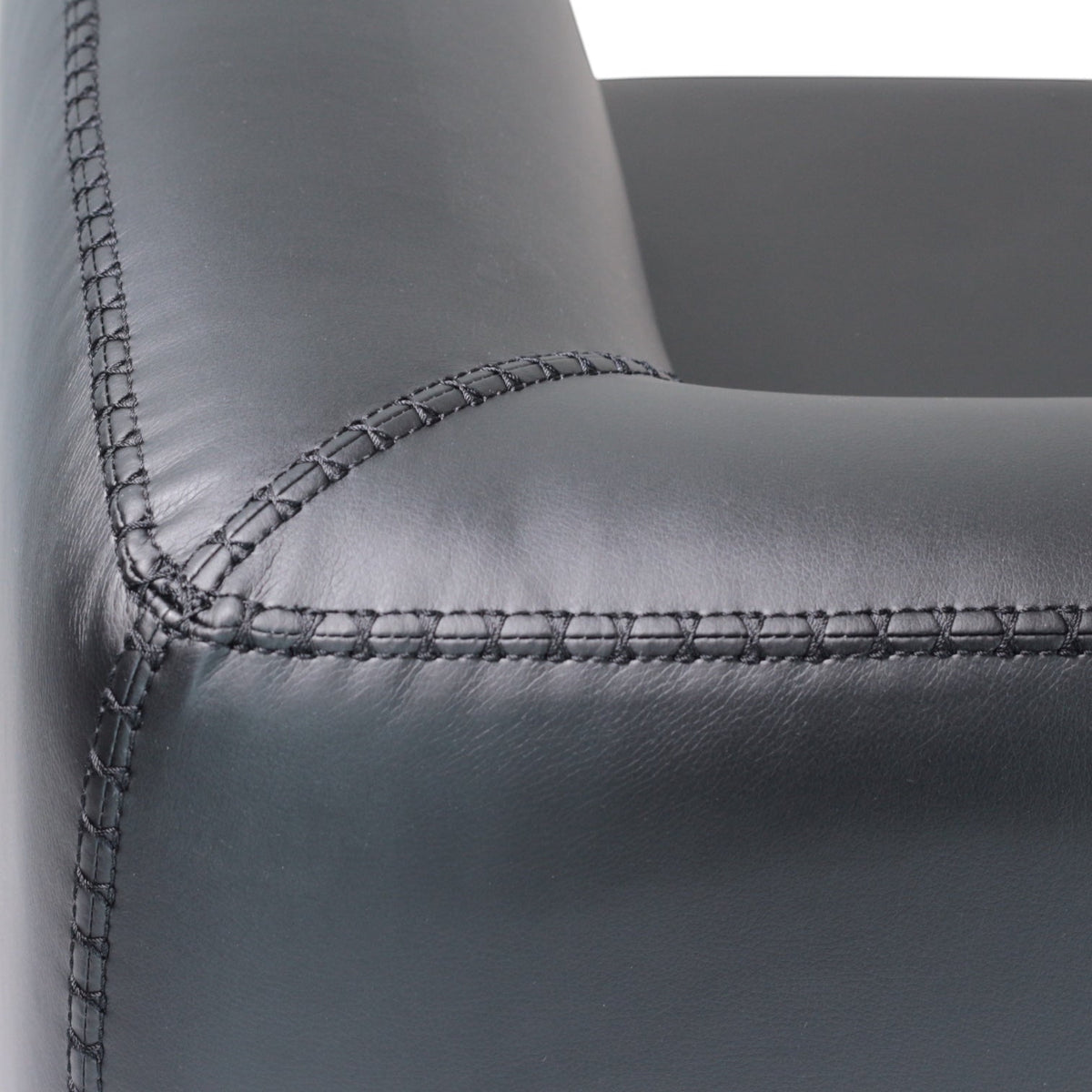 Close-up of the Vaya Home Regalo sofa showing black leather upholstery and stitched seam detail.
