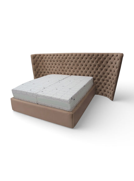 Angled front view of the Vaya Home Regent upholstered bed featuring taupe upholstery and a diamond-tufted wingback headboard.