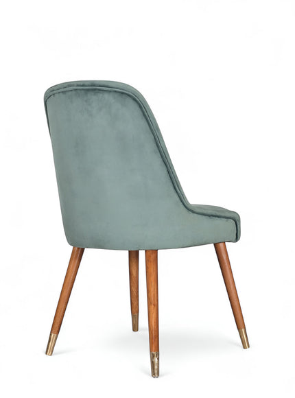 Rear angled view of the Vaya Home Reverie dining chair featuring blue upholstery and tapered wood legs.