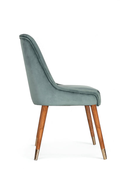 Side view of the Vaya Home Reverie dining chair with blue upholstery, slim profile, and tapered wood legs.