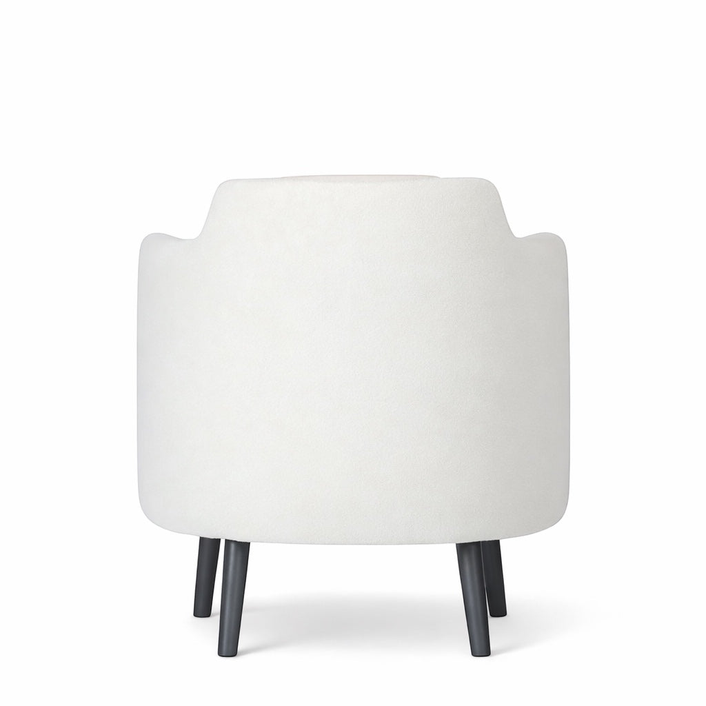 Back view of the Vaya Home Ribbon accent chair featuring ivory upholstery and black tapered legs.