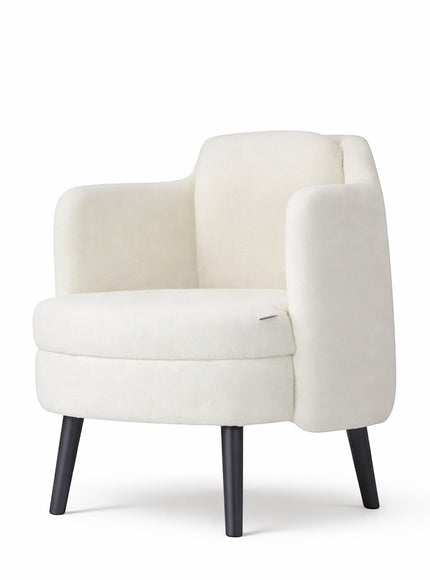 Front angled view of the Vaya Home Ribbon accent chair featuring ivory upholstery, curved arms, and black tapered legs.