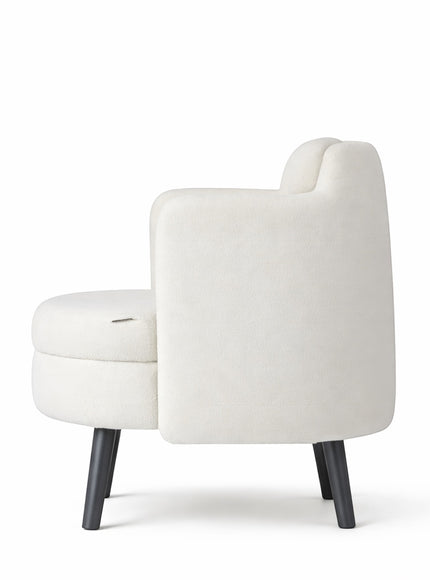 Side rear view of the Vaya Home Ribbon accent chair with ivory upholstery, curved backrest, and black tapered legs.