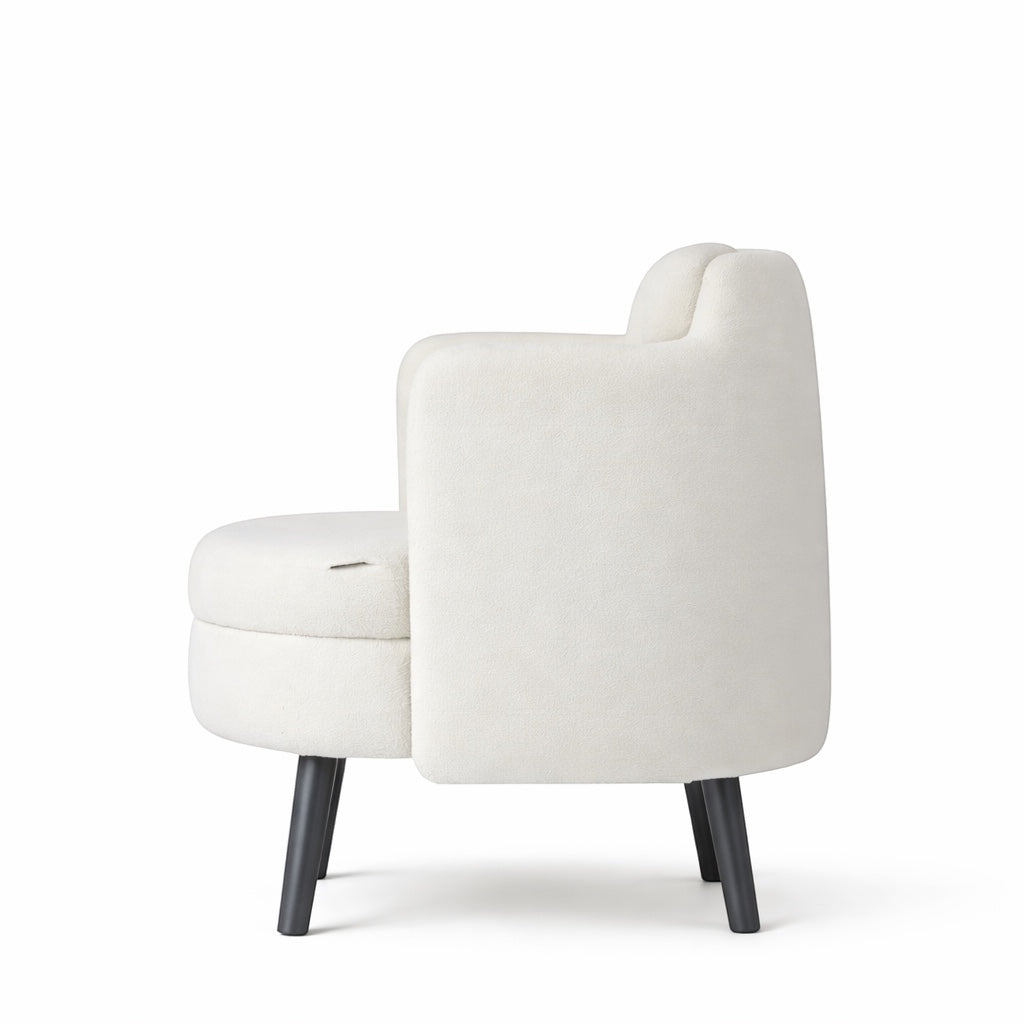 Side rear view of the Vaya Home Ribbon accent chair with ivory upholstery, curved backrest, and black tapered legs.