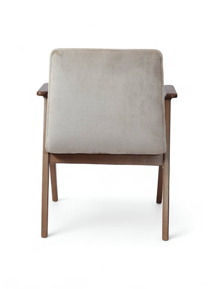 Back view of the Vaya Home Riposo accent chair featuring beige upholstery and angled wood legs.