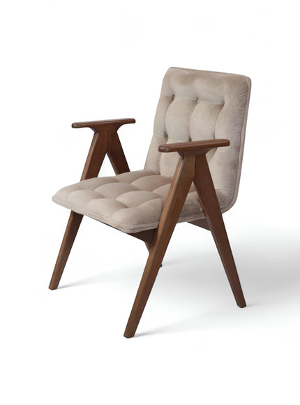 Front angled view of the Vaya Home Riposo accent chair with beige tufted upholstery, sculpted wood arms, and angled wood legs.