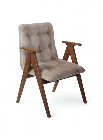 Product view of the Vaya Home Riposo accent chair in beige tufted upholstery with sculpted wood arms and angled wood legs.
