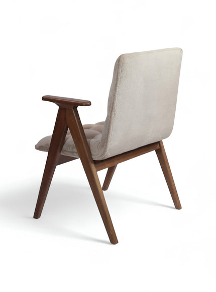 Opposite rear angled view of the Vaya Home Riposo accent chair with beige upholstery, wood arms, and angled wood legs.