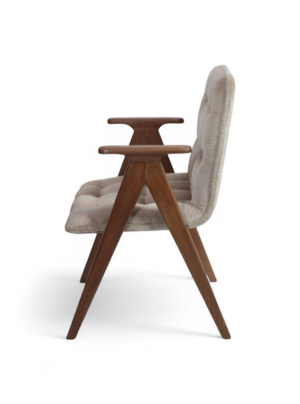 Opposite side view of the Vaya Home Riposo accent chair featuring beige tufted upholstery, sculpted wood arms, and angled wood legs.
