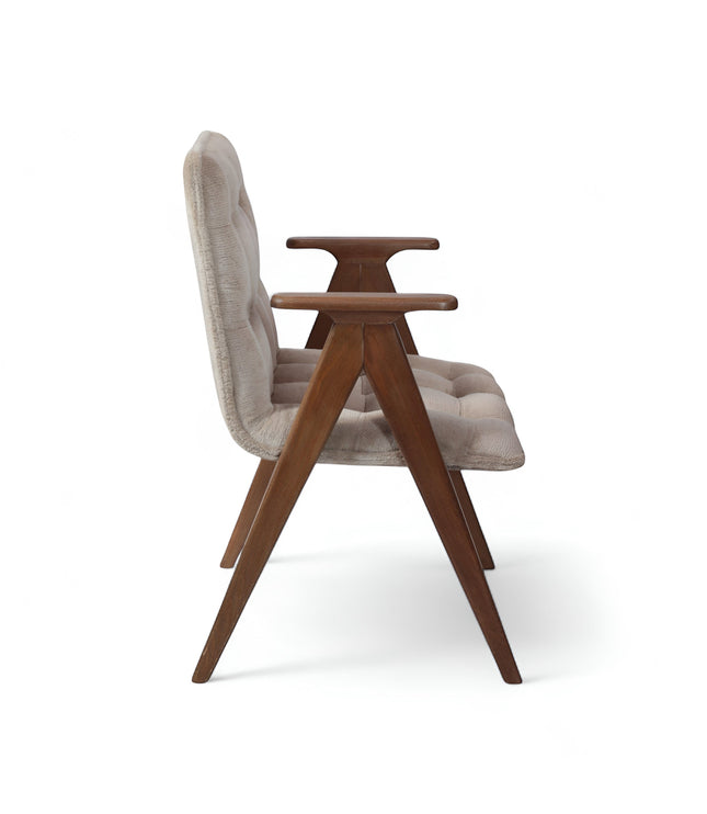 Side view of the Vaya Home Riposo accent chair featuring beige tufted upholstery, sculpted wood arms, and angled wood legs.