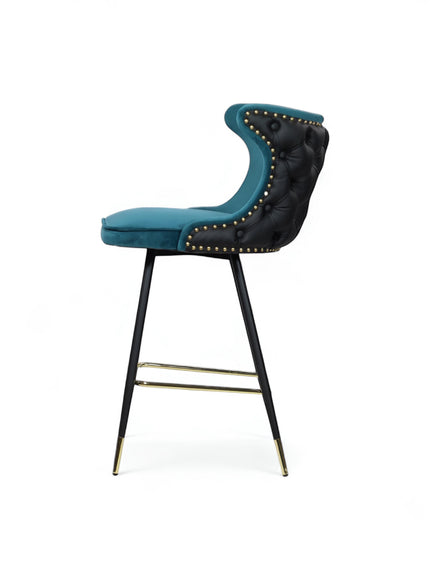 Opposite side view of the Vaya Home Roket bar stool featuring blue seat upholstery, black tufted back, and black metal legs with gold accents.