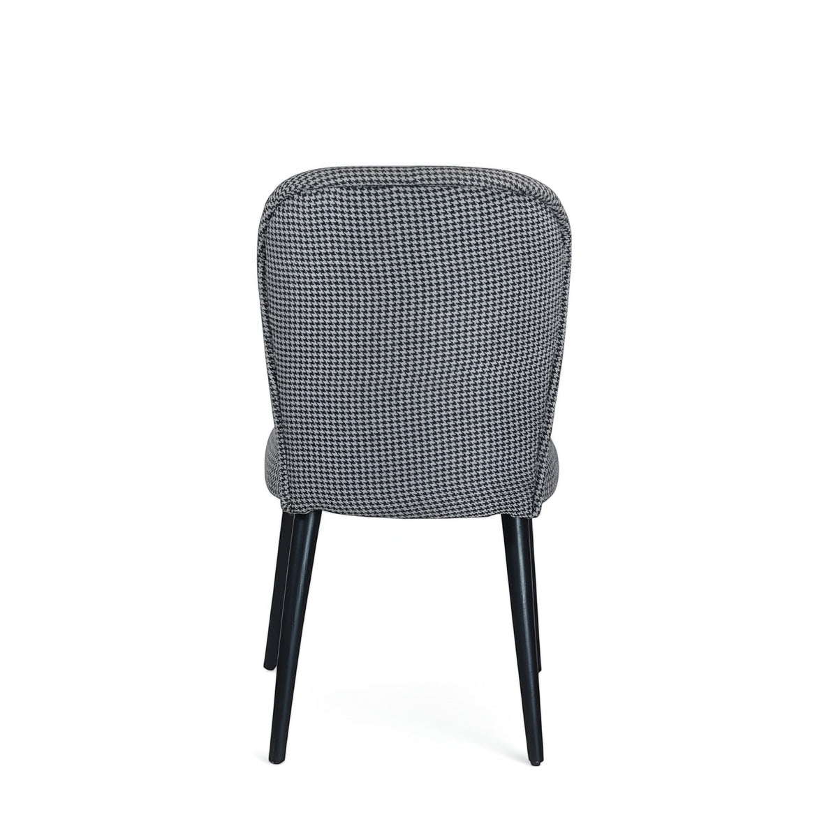 Back view of the Vaya Home Scacchi dining chair featuring black and white houndstooth upholstery and black tapered legs.