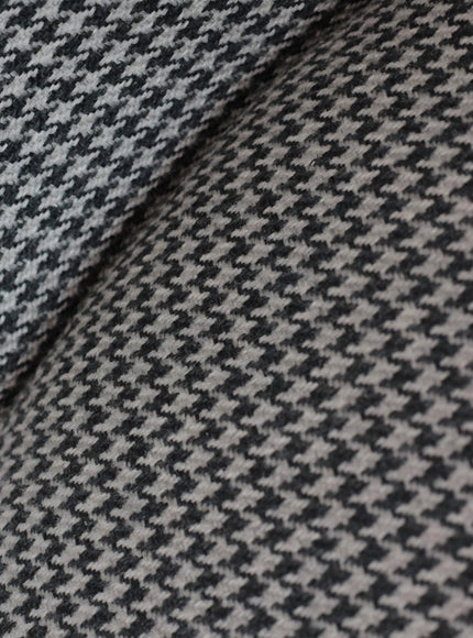 Close-up of the Vaya Home Scacchi dining chair showing black and white houndstooth fabric detail.