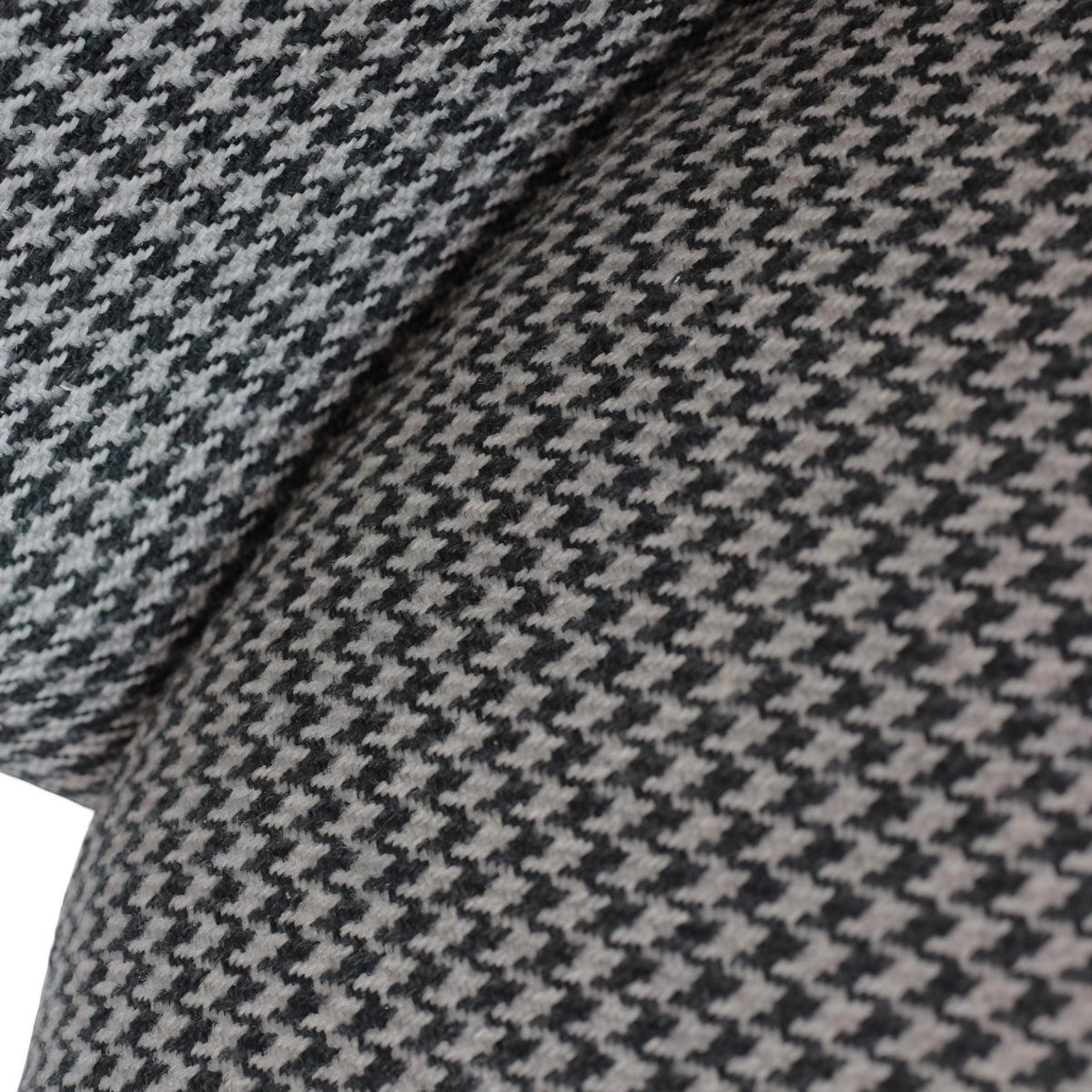 Close-up of the Vaya Home Scacchi dining chair showing black and white houndstooth fabric detail.