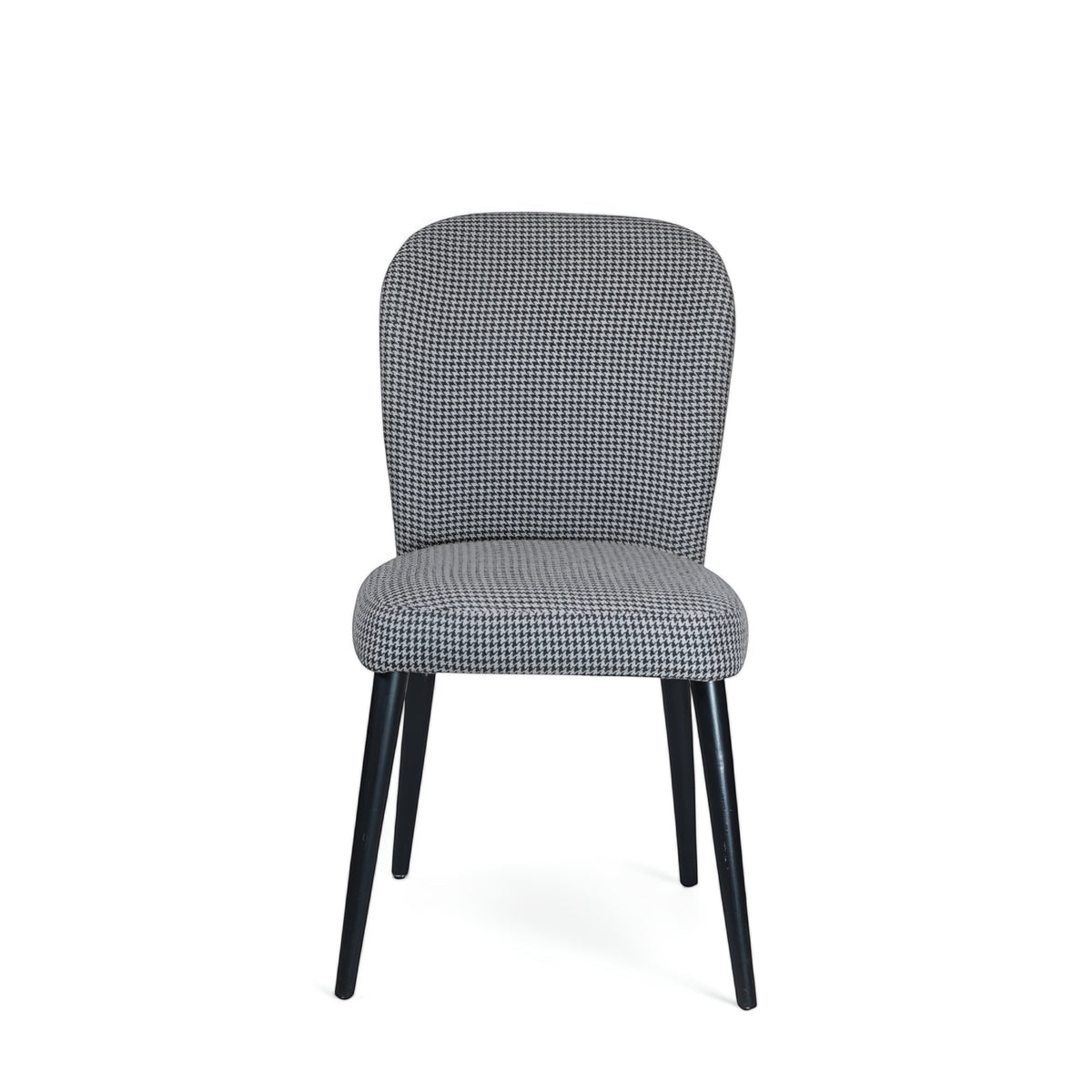 Front view of the Vaya Home Scacchi dining chair with black and white houndstooth upholstery and black tapered legs.