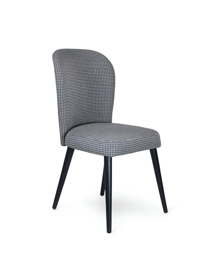 Product view of the Vaya Home Scacchi dining chair in black and white houndstooth upholstery with black tapered legs.