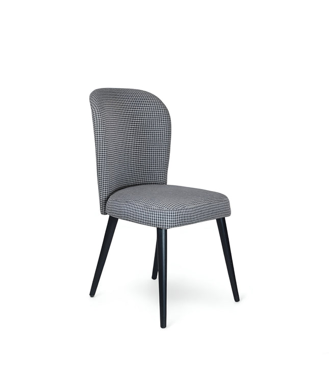 Product view of the Vaya Home Scacchi dining chair in black and white houndstooth upholstery with black tapered legs.