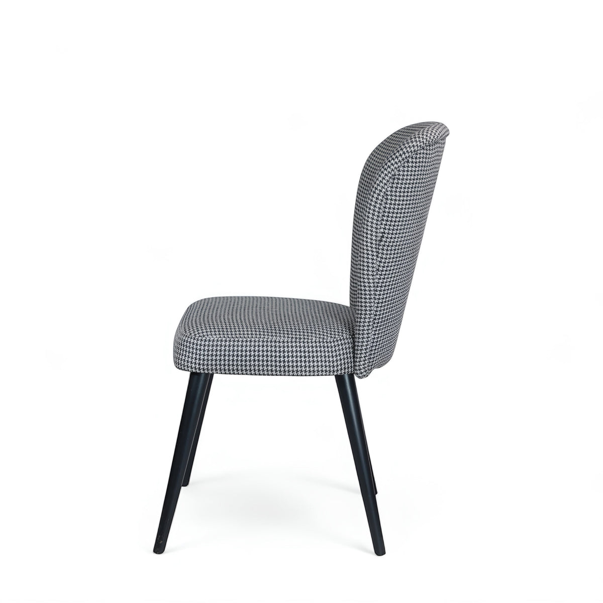 Opposite side view of the Vaya Home Scacchi dining chair with houndstooth upholstery and black tapered legs.