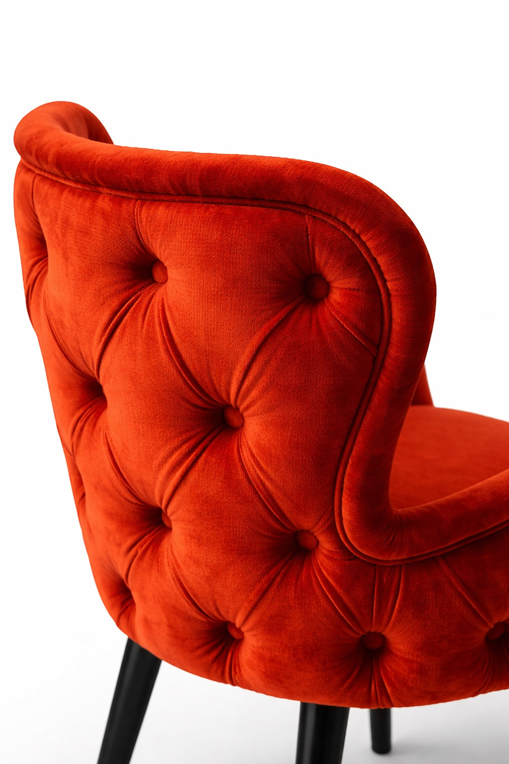 Vaya Home Sienna orange velvet accent chair with button tufting and curved backrest.