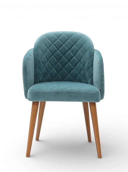 Front view of the Vaya Home Silver dining chair with blue upholstery, diamond-quilted backrest, curved arms, and tapered wood legs.