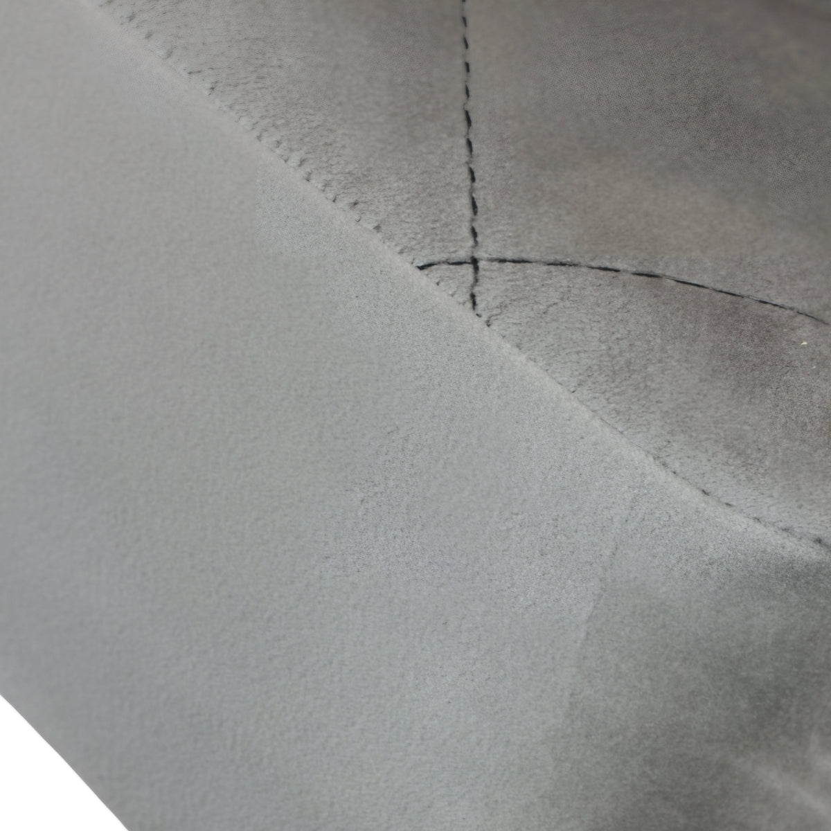 Close-up of the Vaya Home Silver dining chair showing gray upholstery and stitched seam detail.