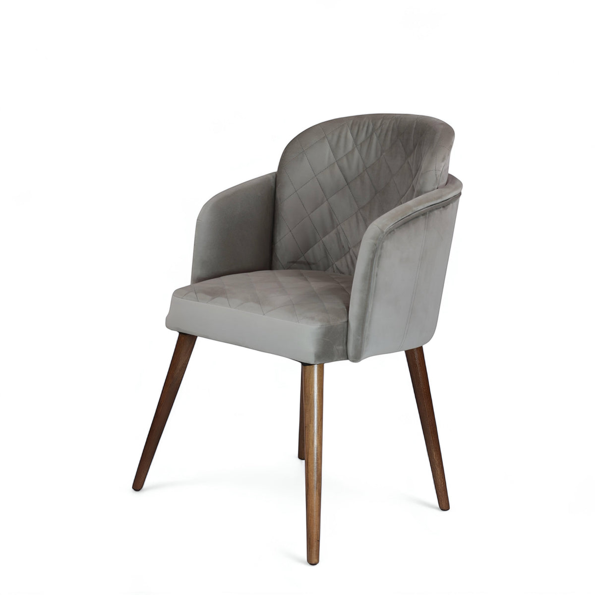 Front angled view of the Vaya Home Silver dining chair with gray upholstery, diamond-quilted backrest, curved arms, and tapered wood legs.