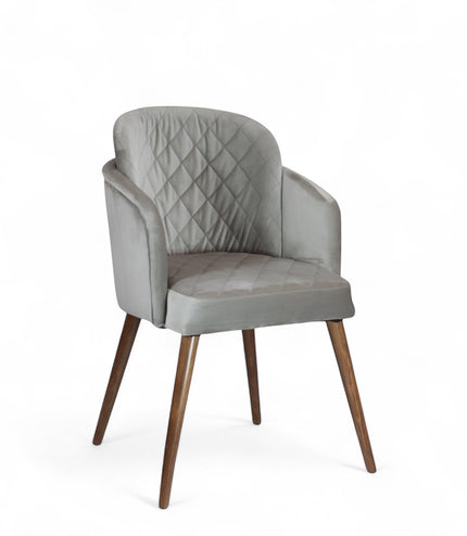 Product view of the Vaya Home Silver dining chair in gray upholstery with curved arms and tapered wood legs.