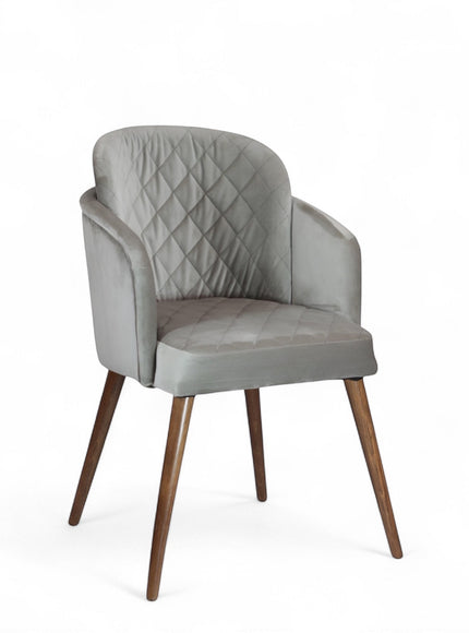 Product view of the Vaya Home Silver dining chair in gray upholstery with curved arms and tapered wood legs.
