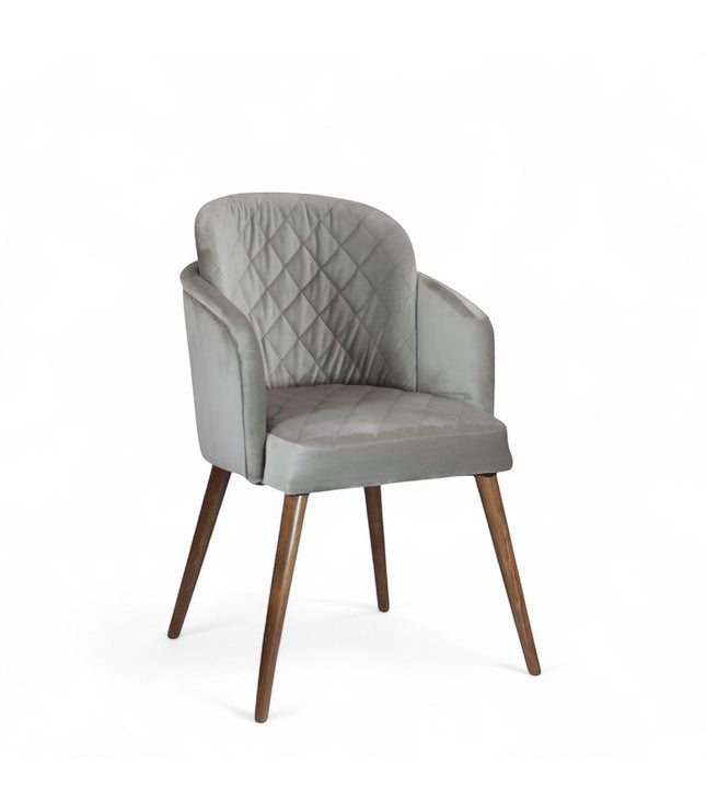 Product view of the Vaya Home Silver dining chair in gray upholstery with curved arms and tapered wood legs.