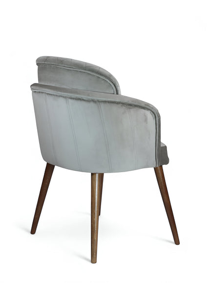 Rear angled view of the Vaya Home Silver dining chair featuring gray upholstery, rounded back, and tapered wood legs.