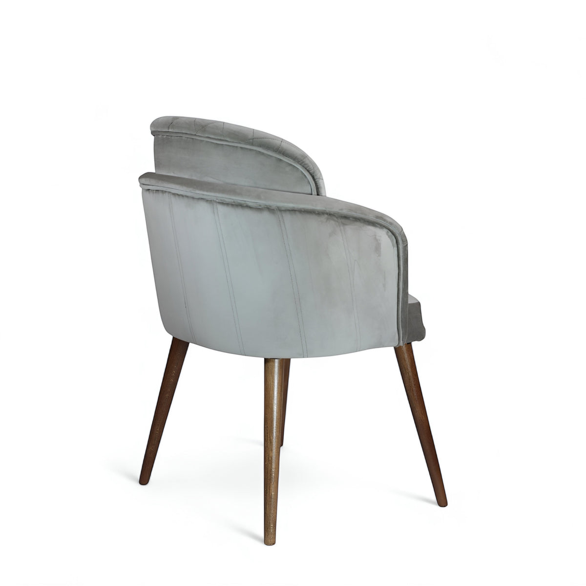 Rear angled view of the Vaya Home Silver dining chair featuring gray upholstery, rounded back, and tapered wood legs.
