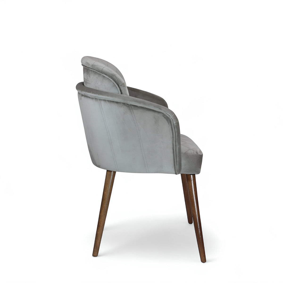 Side rear view of the Vaya Home Silver dining chair with gray upholstery, curved back, and tapered wood legs.