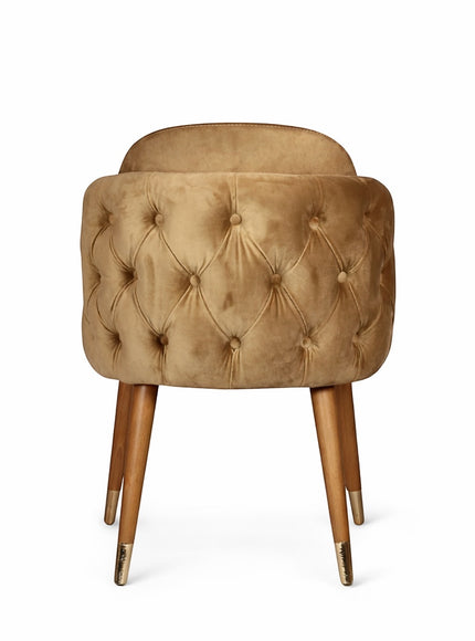 Back view of the Vaya Home Sorelle dining chair showing beige velvet upholstery, button-tufted back detail, and tapered wood legs.