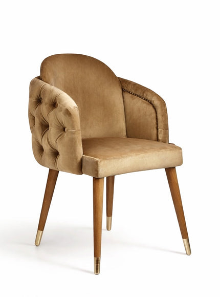 Vaya Home Sorelle dining chair with beige velvet upholstery, tufted back detail, curved arms, and gold leg caps.