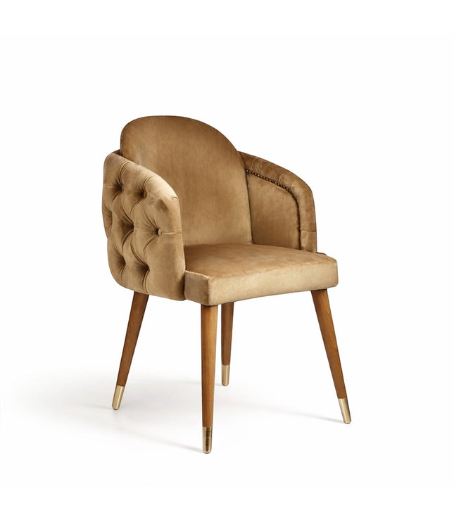 Vaya Home Sorelle dining chair with beige velvet upholstery, tufted back detail, curved arms, and gold leg caps.