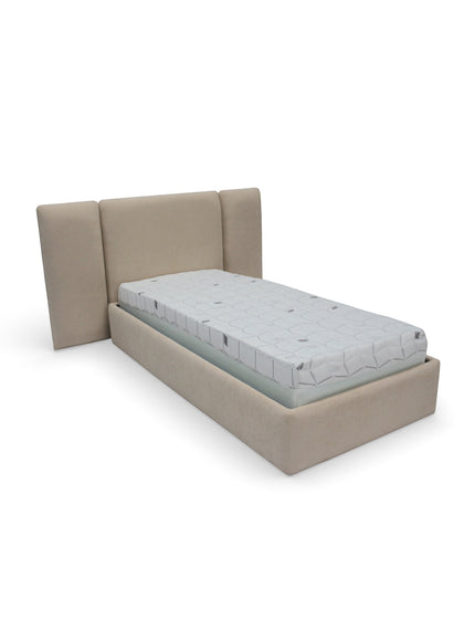 Angled view of the Vaya Home Sutton kids upholstered bed featuring beige fabric upholstery and a wingback headboard.