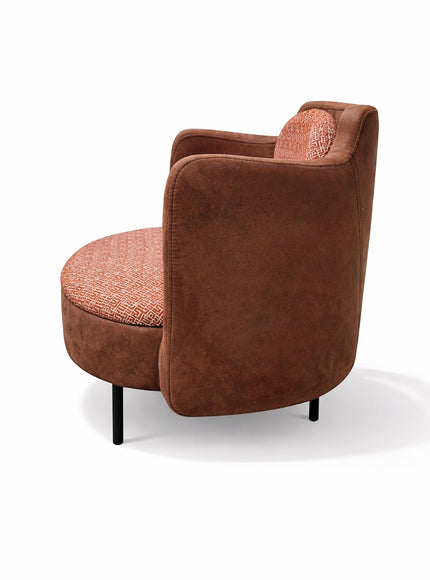 Vaya Home Terracotta armchair in brown eco-leather with orange geometric patterned upholstery on seat and cushion.