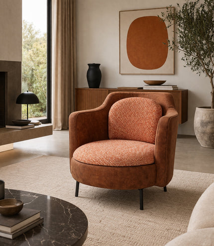 Vaya Home Terracotta armchair with rounded silhouette, brown eco-leather exterior, and orange geometric patterned upholstery.