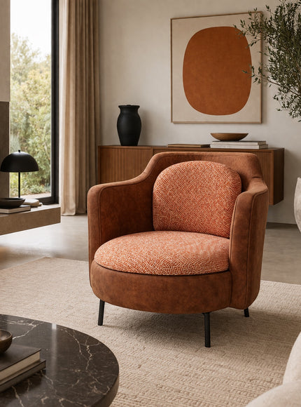 Vaya Home Terracotta armchair with rounded silhouette, brown eco-leather exterior, and orange geometric patterned upholstery.