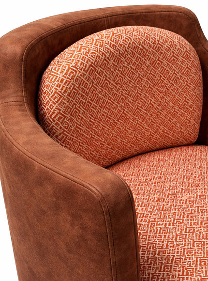 Vaya Home Terracotta armchair with brown eco-leather exterior and orange geometric patterned upholstery. Curved silhouette.