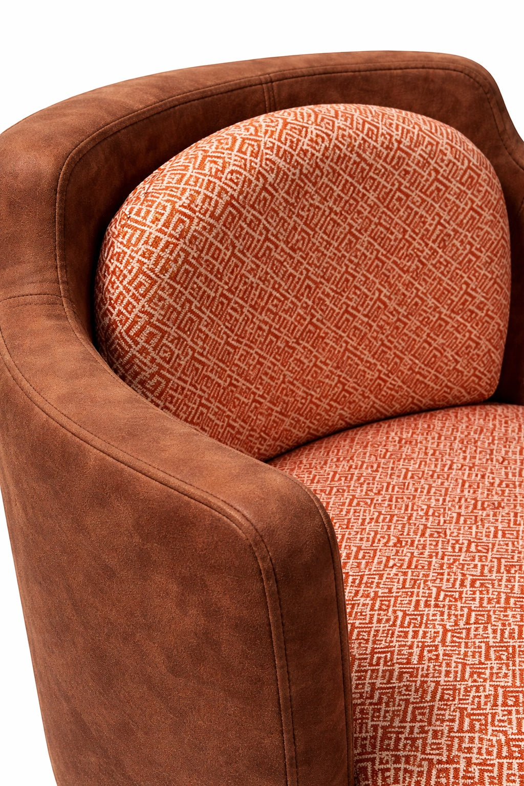Vaya Home Terracotta armchair with brown eco-leather exterior and orange geometric patterned upholstery. Curved silhouette.
