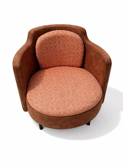 Vaya Home Terracotta armchair with rounded silhouette, brown eco-leather exterior, and orange geometric patterned upholstery on seat and back.