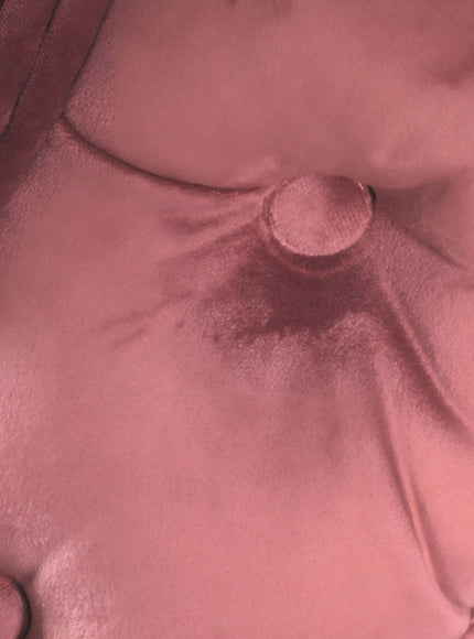 Close-up of the Vaya Home Toffel bar stool showing pink velvet upholstery and button-tufted detail.
