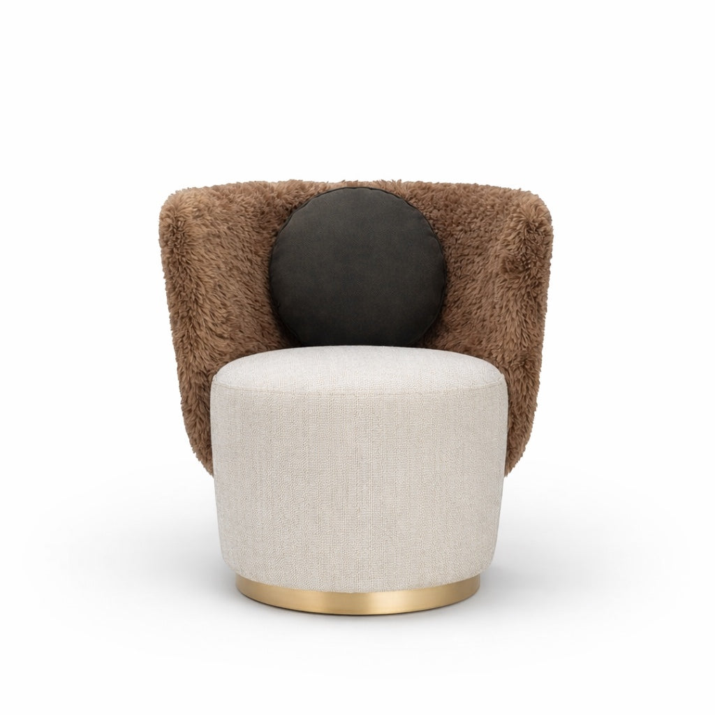 Front view of the Vaya Home Valmont accent chair with a cream upholstered seat, brown textured wraparound back, gold base trim, and black round cushion.