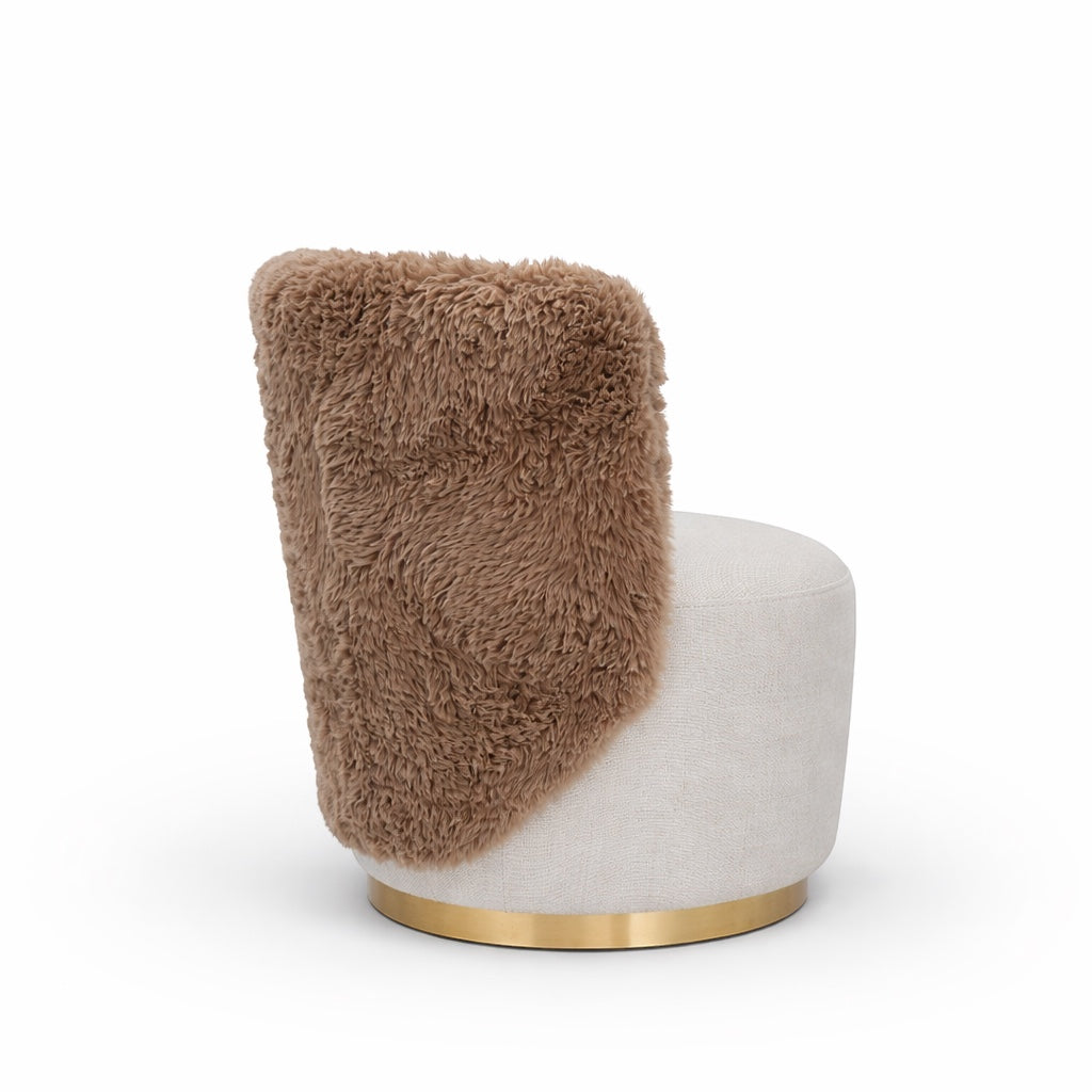 Side view of the Vaya Home Valmont accent chair showing a brown textured outer back, cream upholstered seat, and gold base trim.