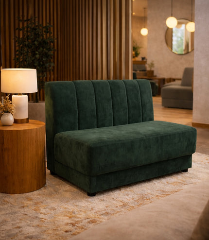 Vaya Home Vert armless loveseat in deep green velvet, styled in a modern interior.