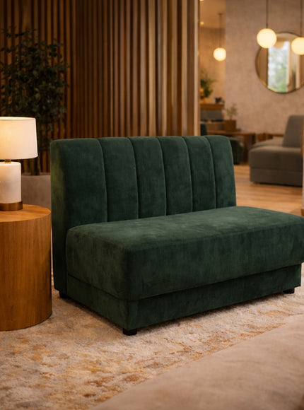 Vaya Home Vert armless loveseat in deep green velvet, styled in a modern interior.