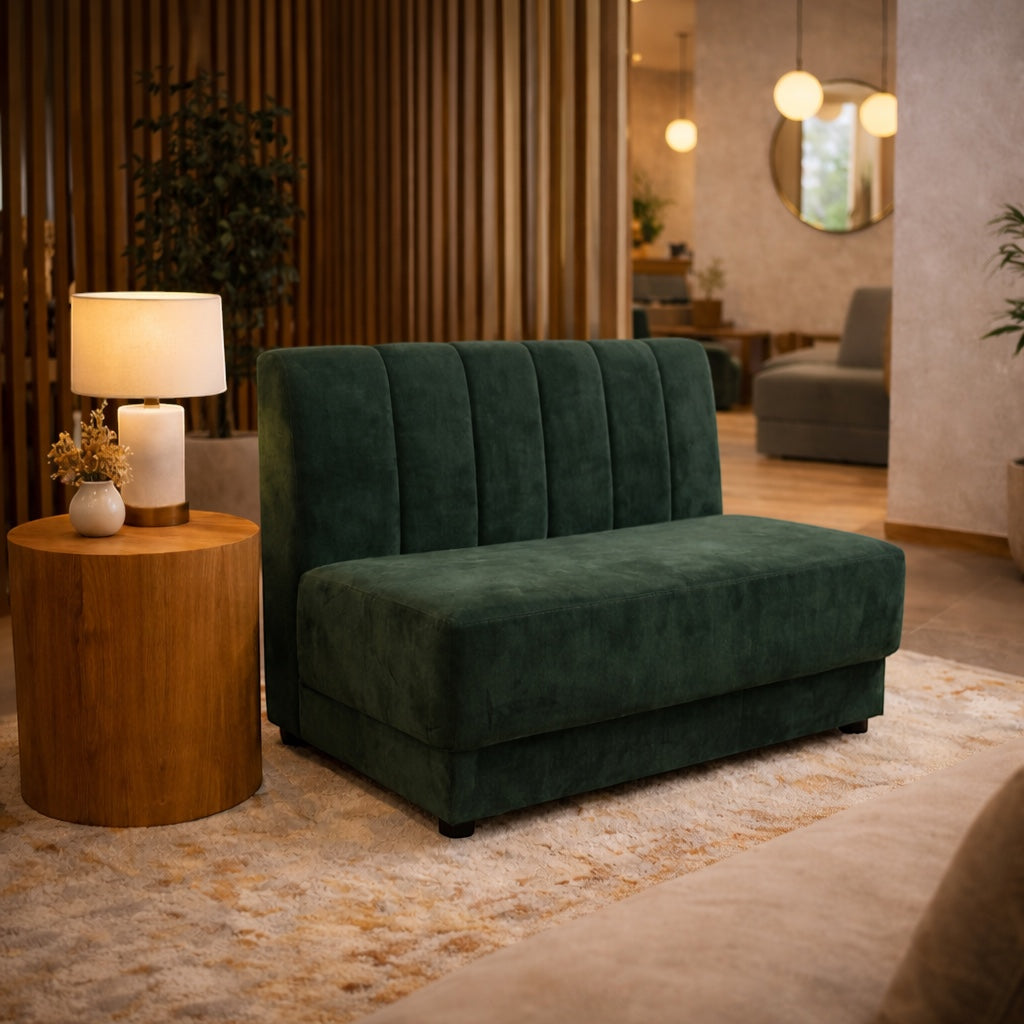 Vaya Home Vert armless loveseat in deep green velvet, styled in a modern interior.