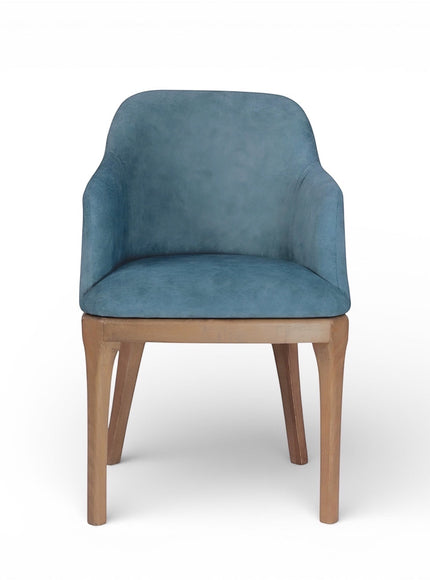 Front view of the Vaya Home Verve dining chair featuring blue upholstery, integrated arms, and tapered wood legs.